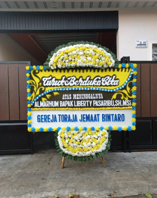 Papan Bunga Duka di Bika